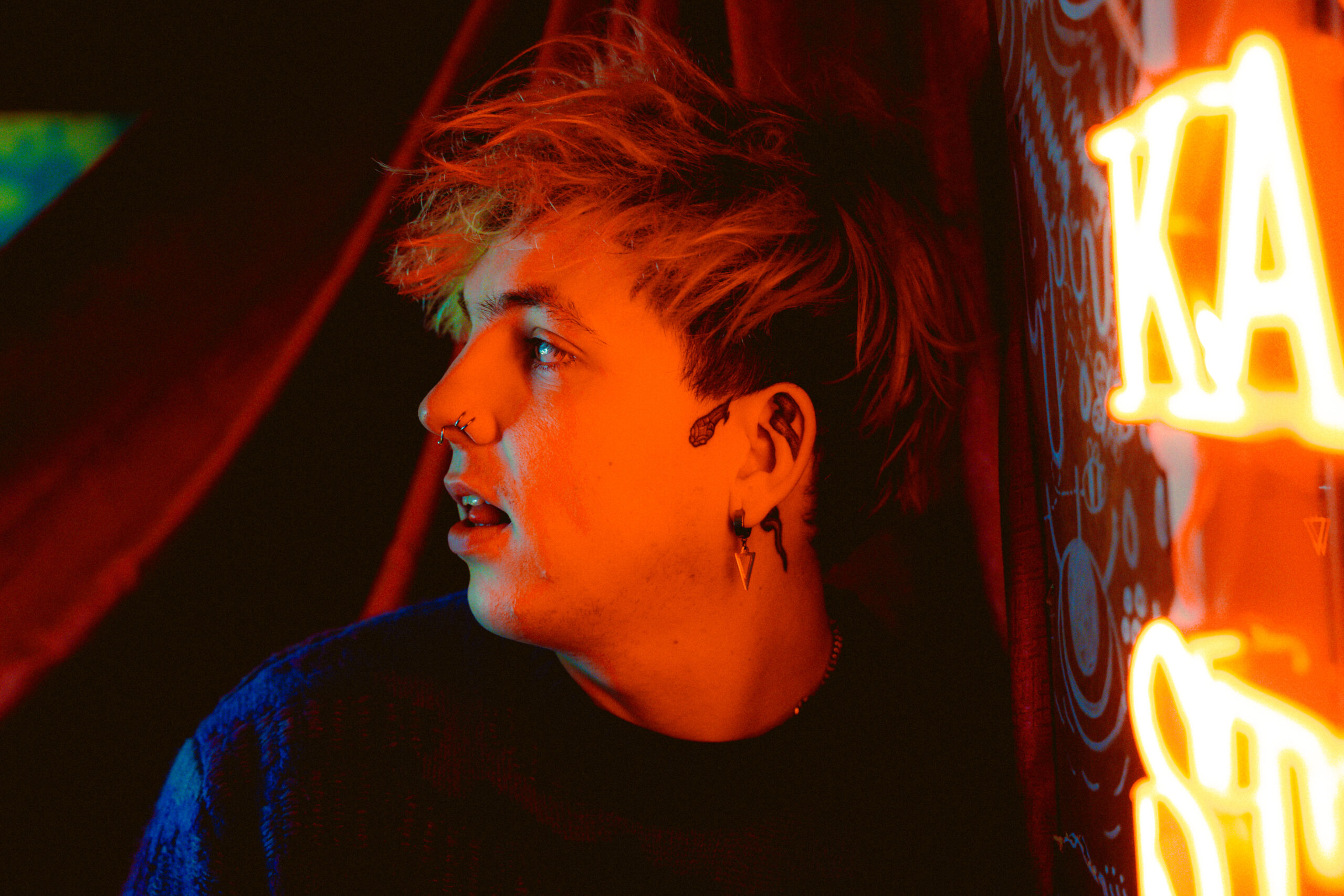 Portrait of Seán Downey in neon light
